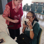 A woman is finally able to read with new glasses donated by Utah residents