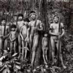 Standing Tall, Awá men and boys, in the Território Indígena Awá, in the Brazilian Amazon - Photograph by Sebastião Salgado