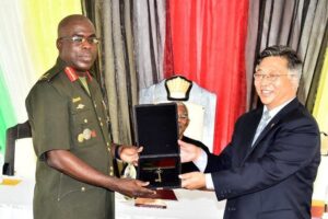 Ambassador of the PRC to Guyana, Mr. Cui Jianchun performs a ceremonial handing over of keys to Chief of Staff of the GDF