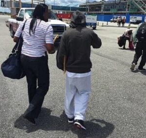 Anthony Bhupdeo, 25, being escorted onto a commercial flight by ICE Enforcement and Removal Operations personnel